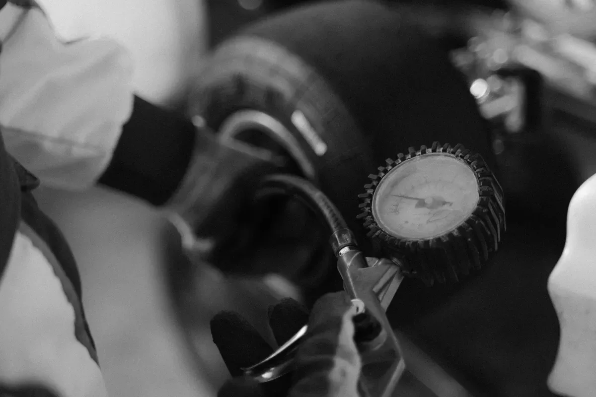 Close-up of a handheld tire pressure gauge with the needle on the dial